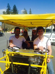 Muns with her companions in the yellow, four-person bicycle.